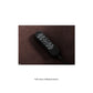 Black Mega Motion remote control sitting on chair